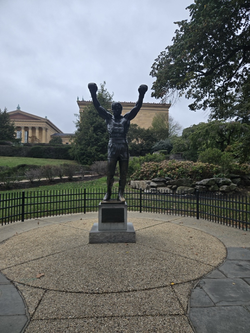 a statue of a man with his arms up in the air