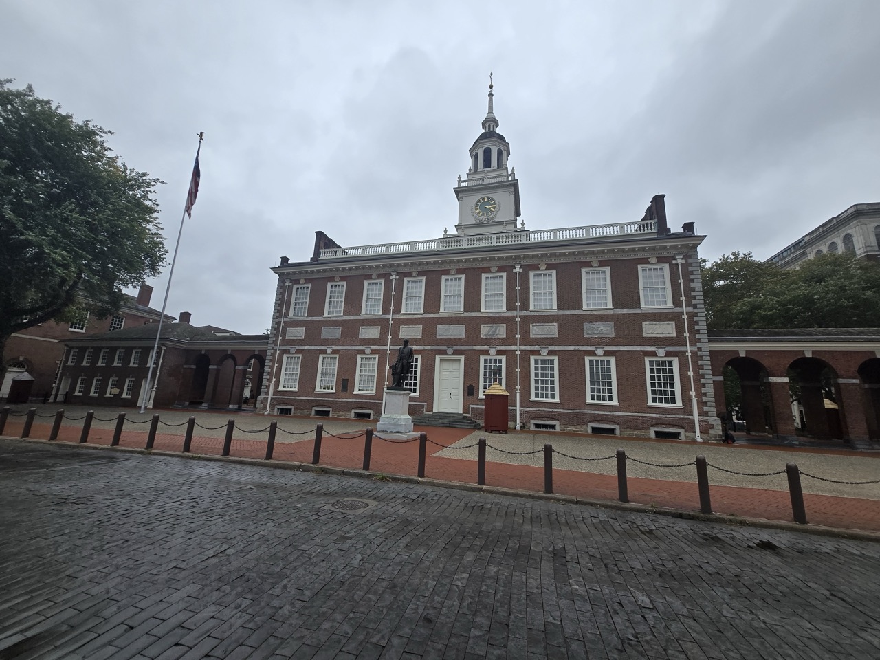 a brick building with a clock tower and a statue on top