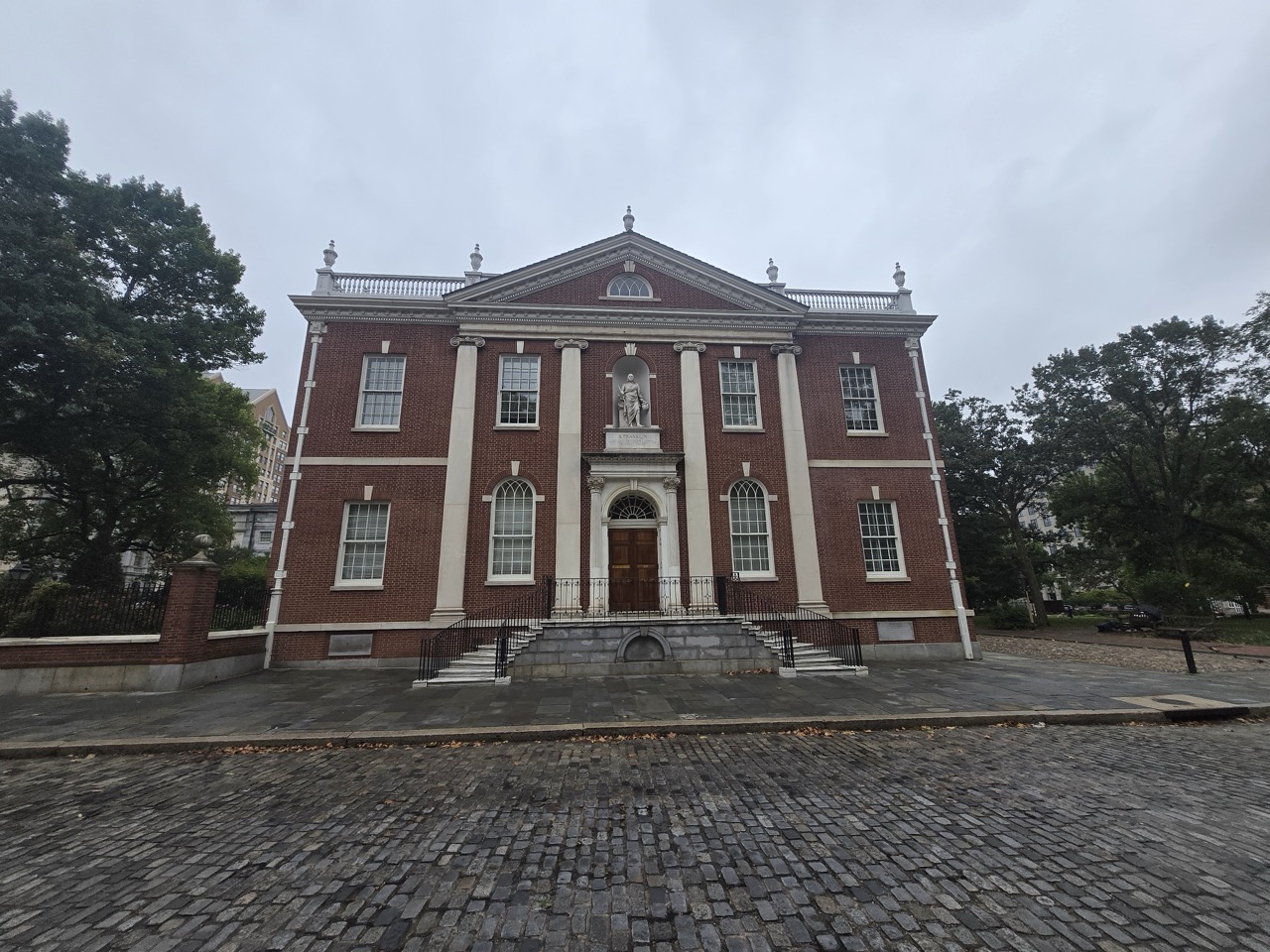 a brick building with a statue on the front