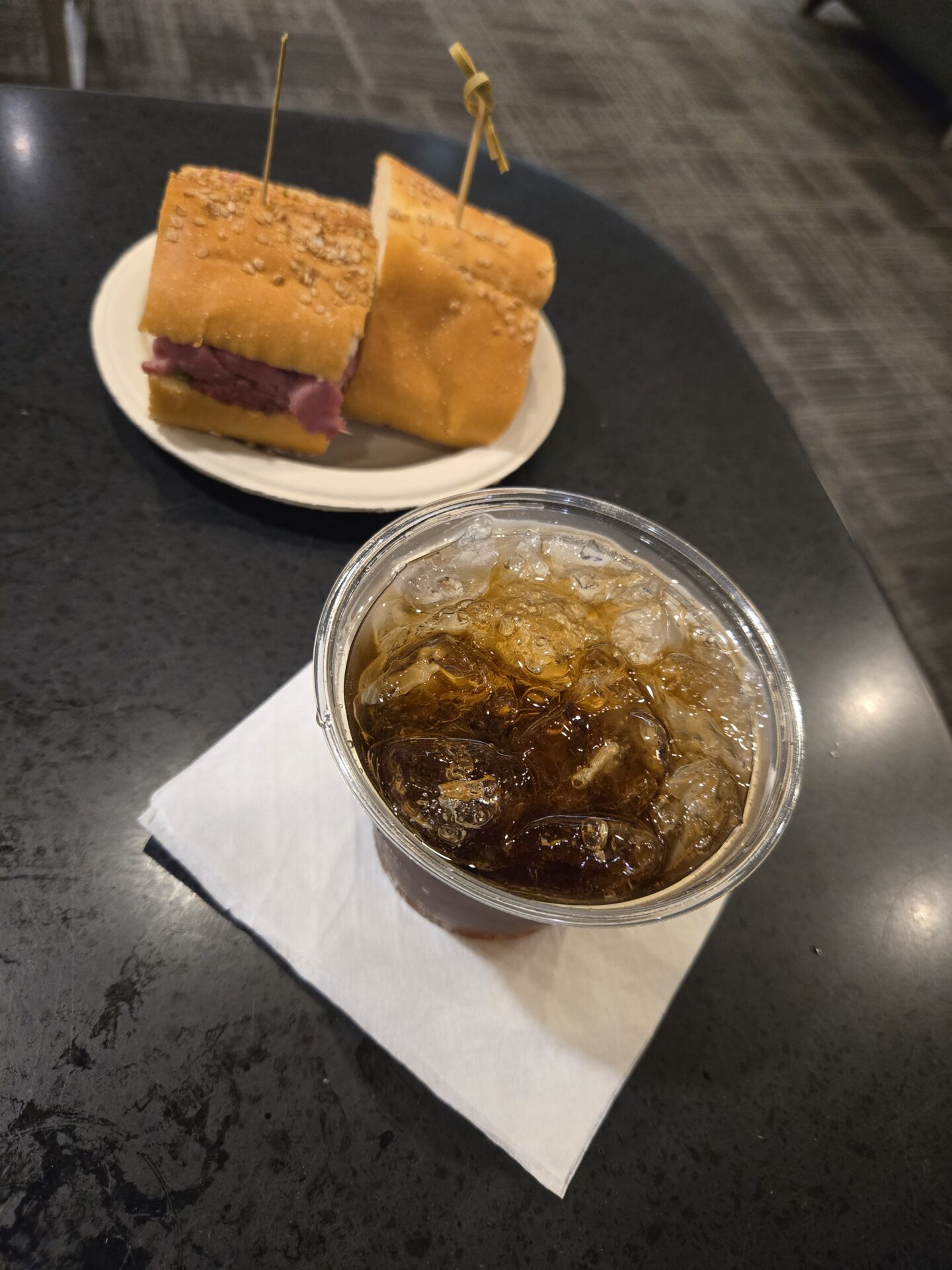a sandwich and ice on a plate