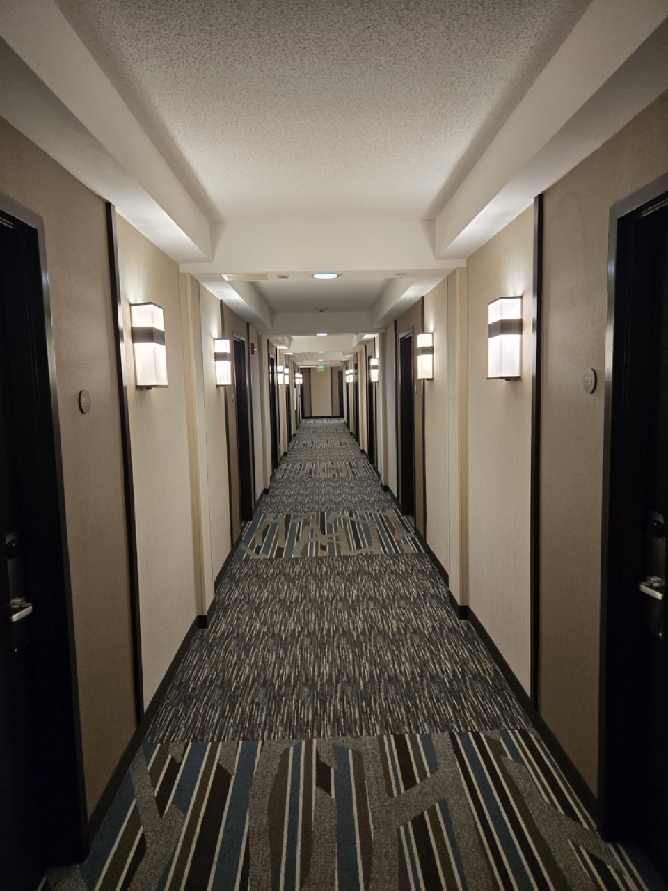 a hallway with lights on the wall