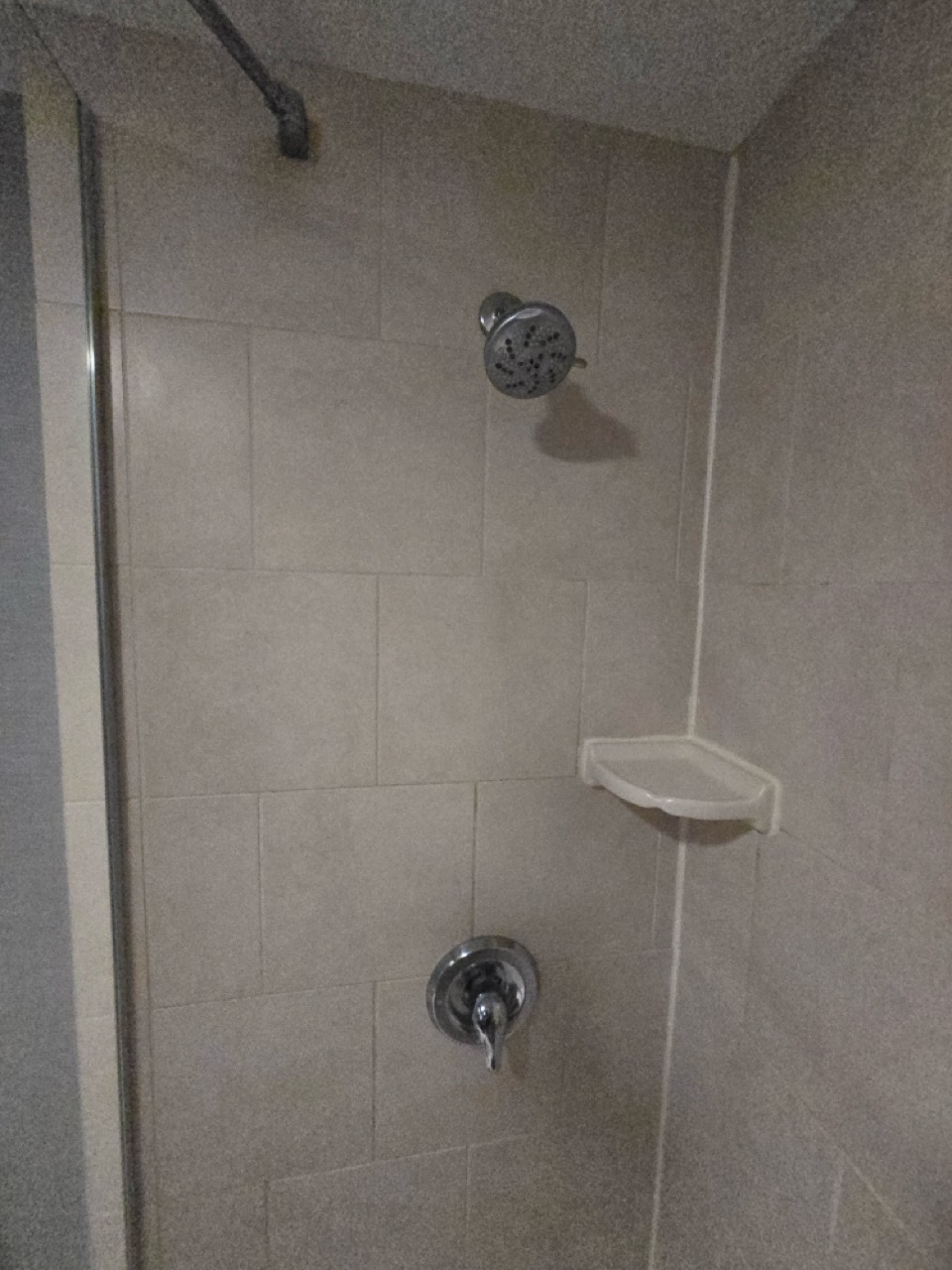 a shower head and a shelf