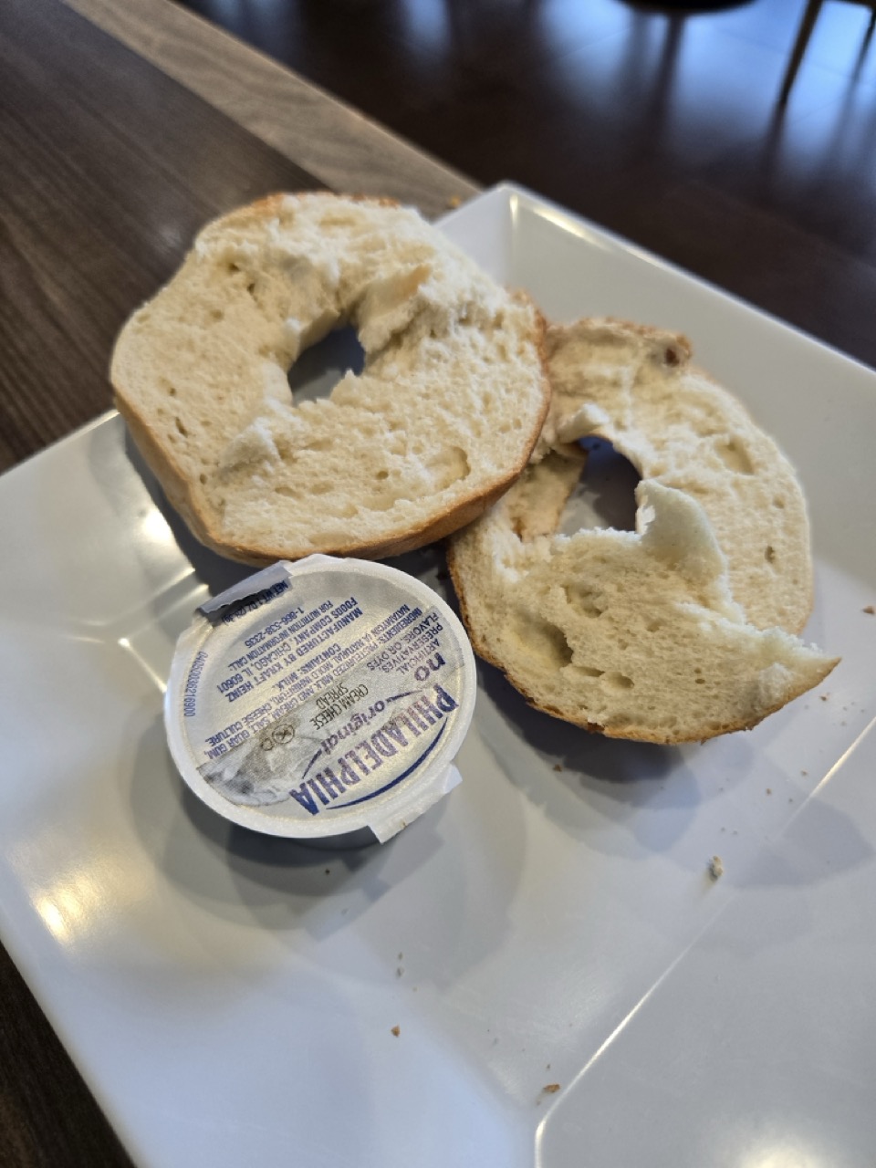 a bagel and cheese on a plate