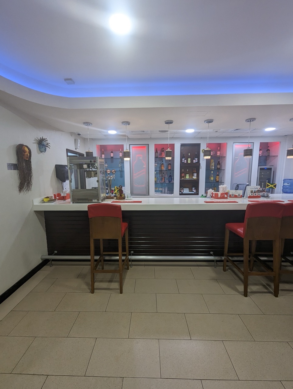 a bar with chairs and a counter