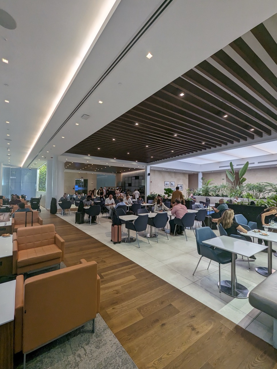 a group of people sitting at tables in a room with chairs and tables