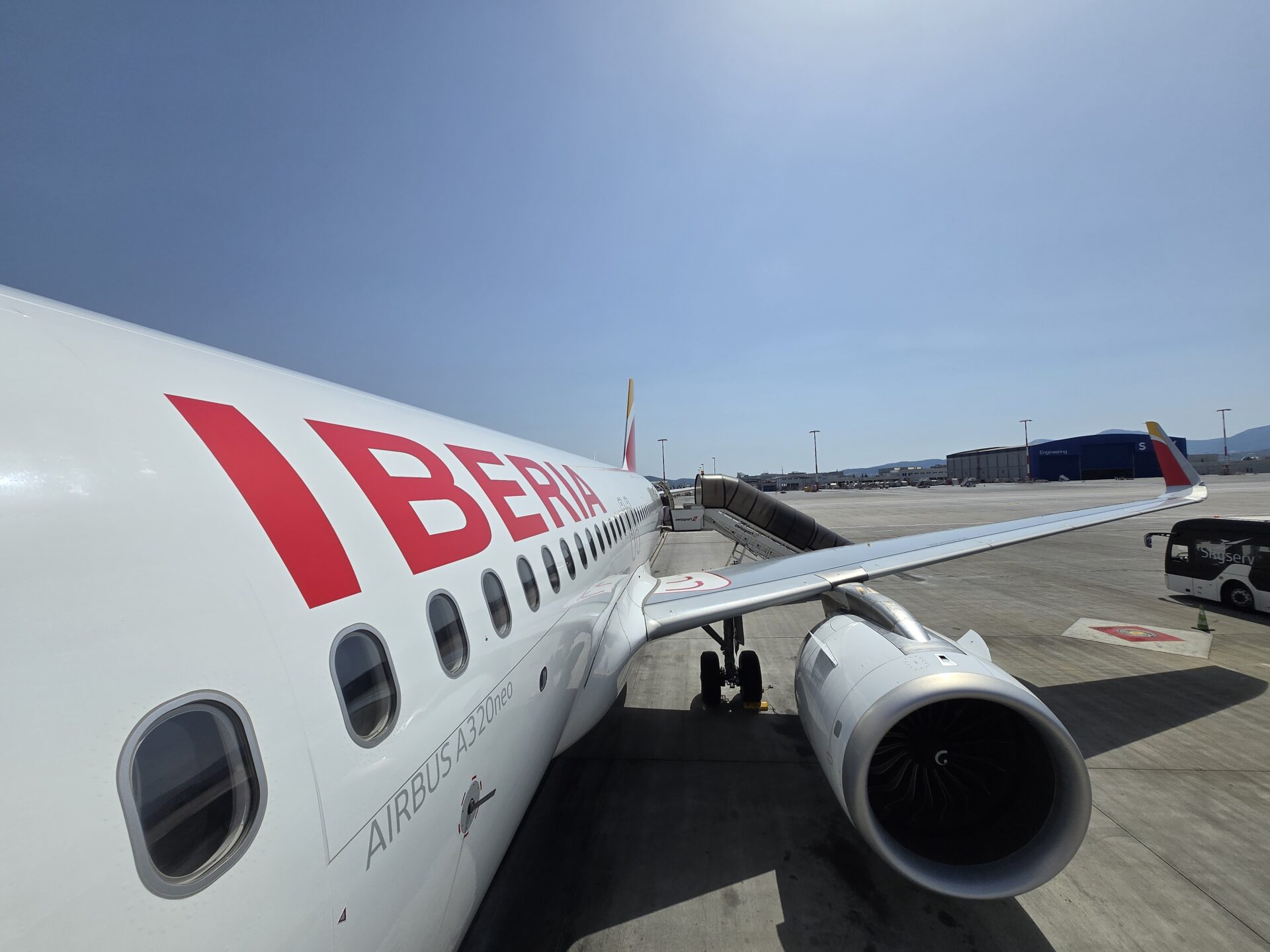 a white airplane with red writing on it