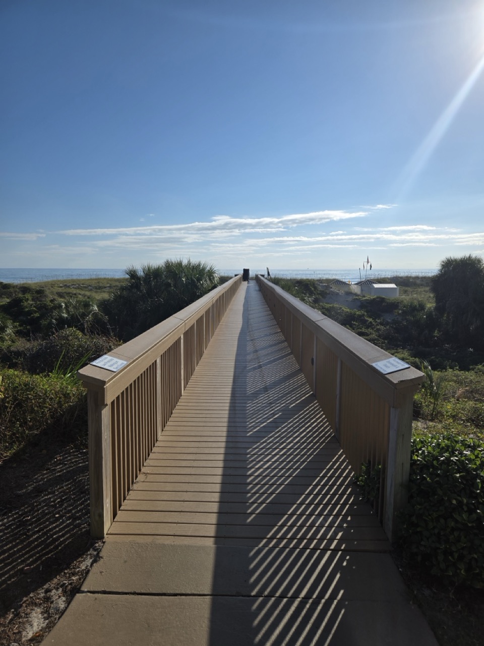 a wooden bridge over a beach