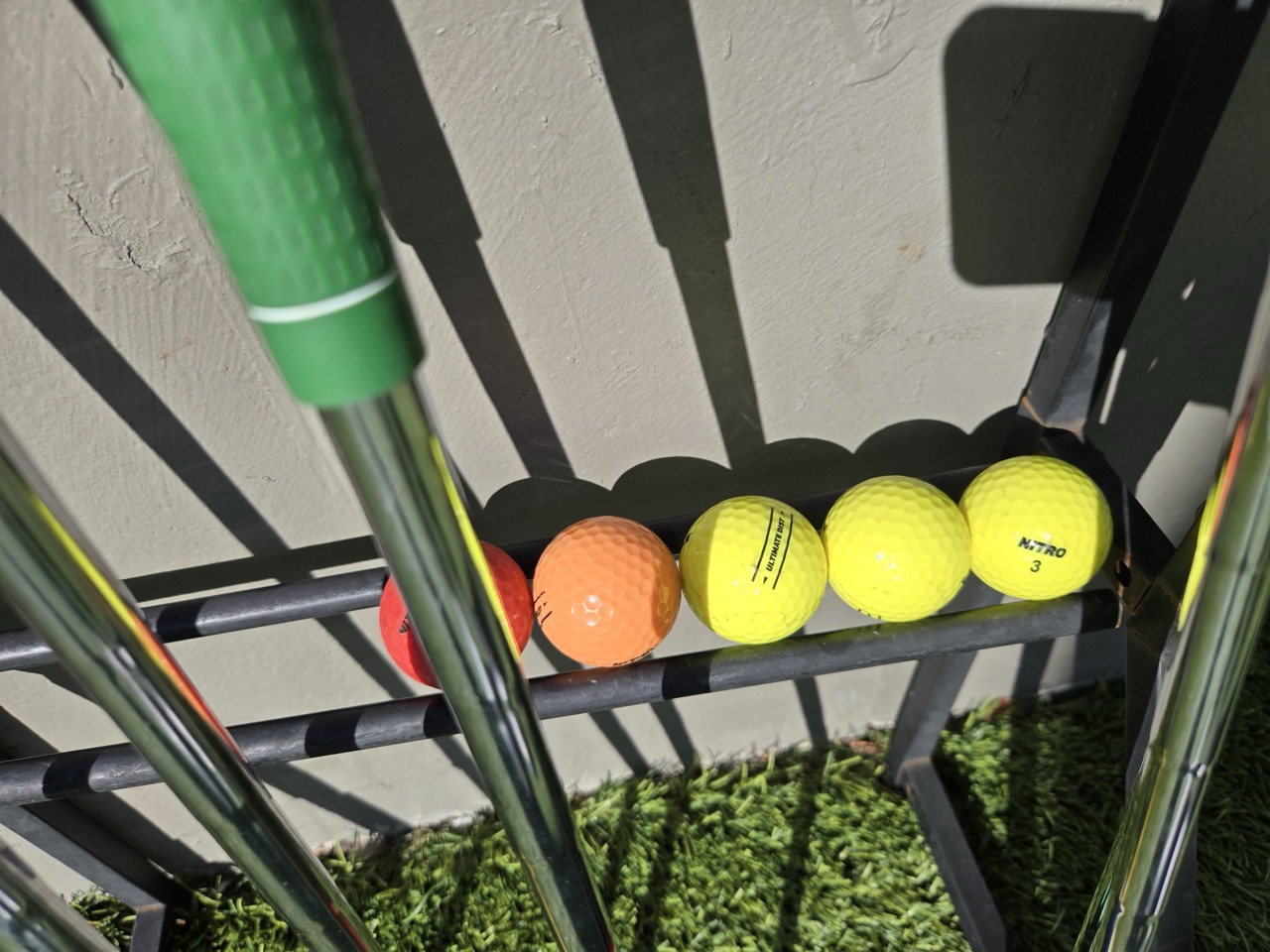 a group of golf balls on a rack