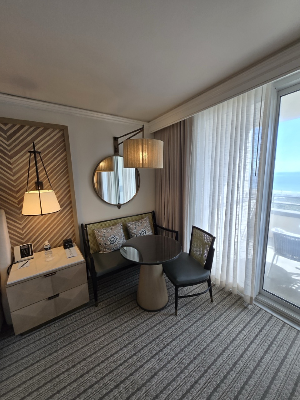 a room with a table and chairs and a table and a mirror