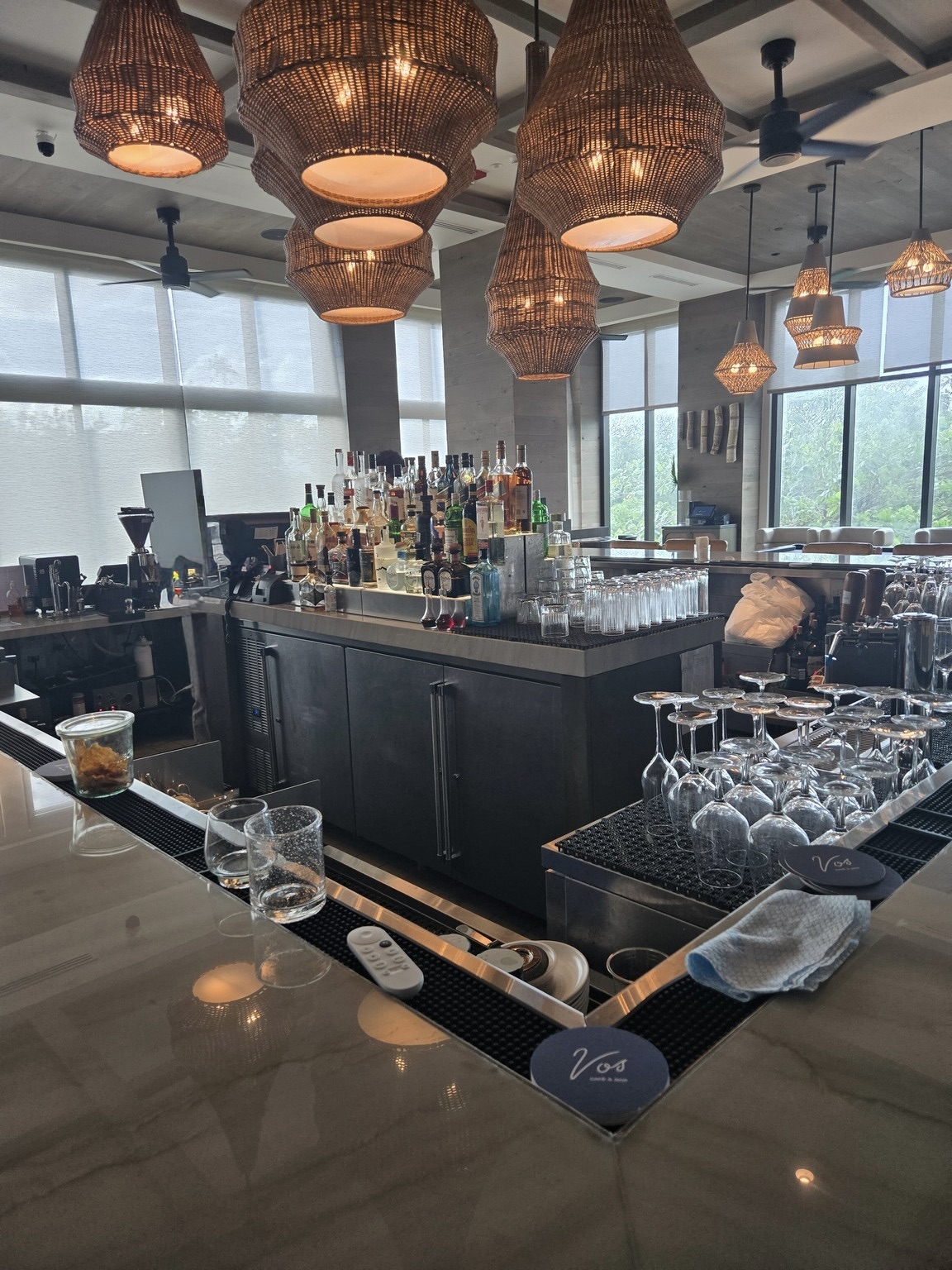 a bar with many glasses and bottles