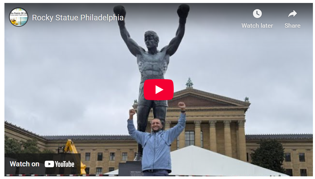 a man standing in front of a statue